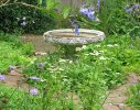 A small blue and white formal garden creates an additional 'room' within the main garden